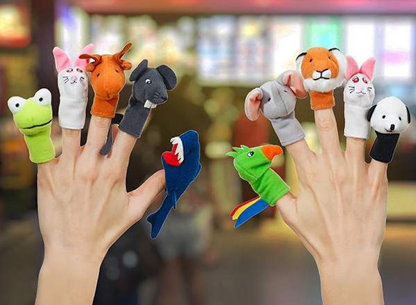 close-up of woman's hands wearing 10 finger puppets